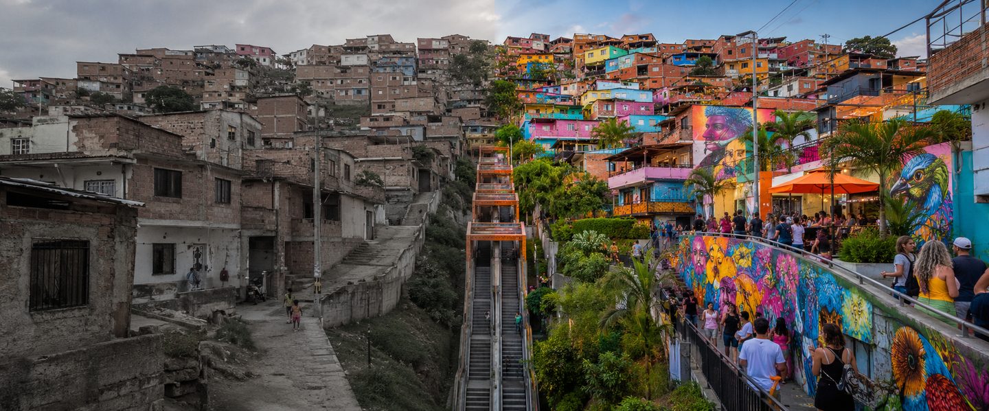 Comuna 13 neighborhood transformation — colorful murals and community life